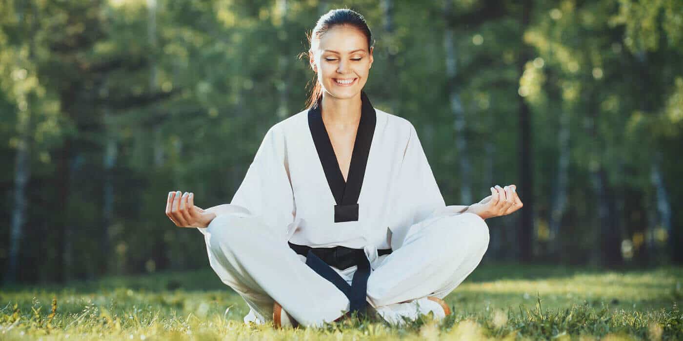 Martial Arts Lessons for Adults in Wentzville MO - Happy Woman Meditated Sitting Background